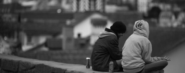 two men sitting and talking